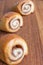 Close-up of diagonal gingerbread rolls, the first focused, others in bokeh on wooden table in vertical