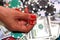 Close up of dice in woman`s hand with cash and chips