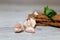 Close-up dietary loaves lying on each other decorated with fresh herbs and a bunch of garlic on a grey wooden table. Dry snacks di