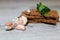 Close-up dietary loaves lying on each other decorated with fresh herbs and a bunch of garlic on a grey wooden table. Dry snacks di