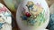 Close-up of different drawings on goose eggs for Easter festival. Eggs on hay. Hand made print. Spring hollidays. Easter