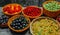 Close up different kind of baskets with fruits in right side of vintage wood background. Red, black and white currant, green. Top