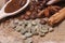 Close-up different types of coffee beans on wooden spoons, green coffee, sticks of cinnamon and anise star, macro, set