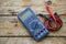 Close-up of digital multimeter on wooden background, Worker used electronic tools for checked circuit