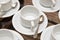 Close up dirty coffee cup and spoon setting on white saucer and wooden table after drinking in the morning in vintage style. cup