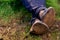 Close up of dirty feet feet crossed and resting on the ground. Famer\\\'s feet