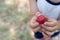 CLOSE UP OF DIRTY LITTLE CHILD HANDS HOLDIND A RED PLUM WITH DEF