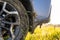 Close up of dirty off road car wheels with dirty tires covered with yellow mud