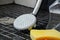 Close up of dirty shower head, cleaning sponge and a spray bottle on the shower floor