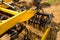 Close up of a disc harrow cultivator at work on a field with stubble