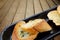 Close-up of a dish of garlic bread on wooden deck table