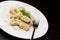 Close-up of dish of italian swivels pasta with porcini mushrooms and sauce bechamel with pepper near fork