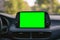 Close up display with green screen on car panel, car driving with navigation concept, blank screen dashboard