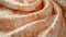 A close-up display of a Peach Fuzz brocade fabric, focusing on the rich, decorative patterns and soft peach color, fully