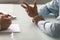 Close up diverse businessman hands talking at meeting.