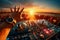 Close-up of DJ hand greeting crowd with hand, spinning turntable at a sunset open air electronic music vacation holiday