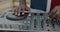 Close-up of DJ\'s hands working with audio equipment creating music at party