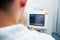 Close up Doctor adjusts electrocardiograph in computed tomography room. Selective focus