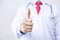 Close up of doctor giving thumbs up in white isolated background