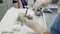 Close-up doctor hands in sterile gloves prepares medical instruments for sclerotherapy surgery