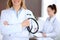 Close up of a doctor holding a stethoscope in his hand while standing in medical office