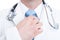 Close-up of doctor or medic with stethoscope adjusting necktie