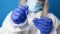 Close up of a doctor in medical PPE suit holds COVID-19 coronavirus PCR test