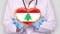 Close-up. Doctor in medical white coat, blue gloves holds in hands drawn pulsating heart with Lebanon flag. Concept of