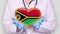 Close-up. Doctor in medical white coat, blue gloves holds in hands drawn pulsating heart with Vanuatu flag. Concept of