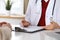 Close up of a doctor and patient hands while discussing medical records after health examination