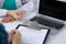 Close up of a doctor and patient sitting at the desk while physician pointing into laptop computer. Medicine and heal