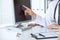 Close-up of a doctor and patient sitting at the desk while physician pointing into monitor computer. Medicine and health