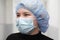 Close-up of the doctor`s eyes. Medical employees in a protective mask and cap