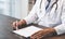 Close up of doctor sitting hands at the table and writing a prescription, Healthcare and medical.