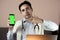 Close-up of doctor using phone at his office, doctor working online, Online consultation. Unrecognizable doctor uses smartphone at