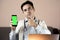 Close-up of doctor using phone at his office, doctor working online, Online consultation. Unrecognizable doctor uses smartphone at