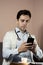 Close-up of doctor using phone at his office, doctor working online, Online consultation. Unrecognizable doctor uses smartphone at