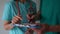 Close-up of doctors hands and documentation. The doctor signs the medical documents in the hands of his assistant