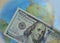 close-up of a dollar bill against the background of a globe. The concept of globalization of the world economy and the