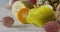 Close-up dolly slow motion of passion fruit, carambola, litchi on a wooden background. Concept of vegetarian diet eating