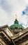 Close-up of the dome of the Kazan Cathedral with a golden cross part of a wall with columns and a frieze with windows, porticoes