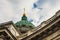 Close-up of the dome of the Kazan Cathedral with a golden cross part of a wall with columns and a frieze with windows, porticoes