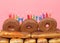 Close up on donut cake with Happy Birthday candles burning