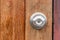 Close up of doorknob with wooden door