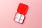 Close-up dose pill box with medical pills on pink background. Top view. Flat lay. Copy space. Pharmaceutical medicine pills