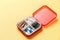 Close-up dose pill box with medical pills on yellow background. Top view. Flat lay. Copy space. Pharmaceutical medicine pills, tab
