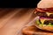 Close up on double cheeseburger on wooden background