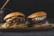 Close-up of double hamburgers on a wooden board