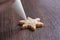 Close up of drawing Christmas snowflake sugar cookie on wooden table background with icing