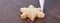 Close up of drawing Christmas snowflake sugar cookie on wooden table background with icing